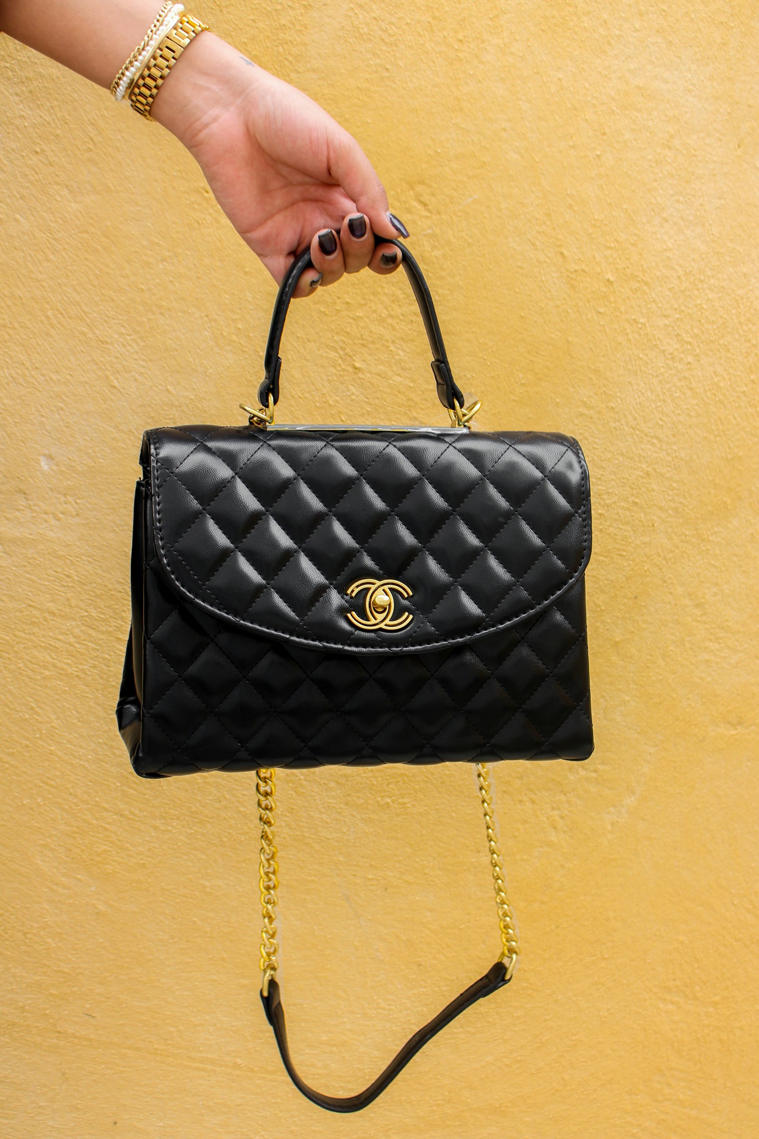 A black quilted Chanel handbag with gold hardware