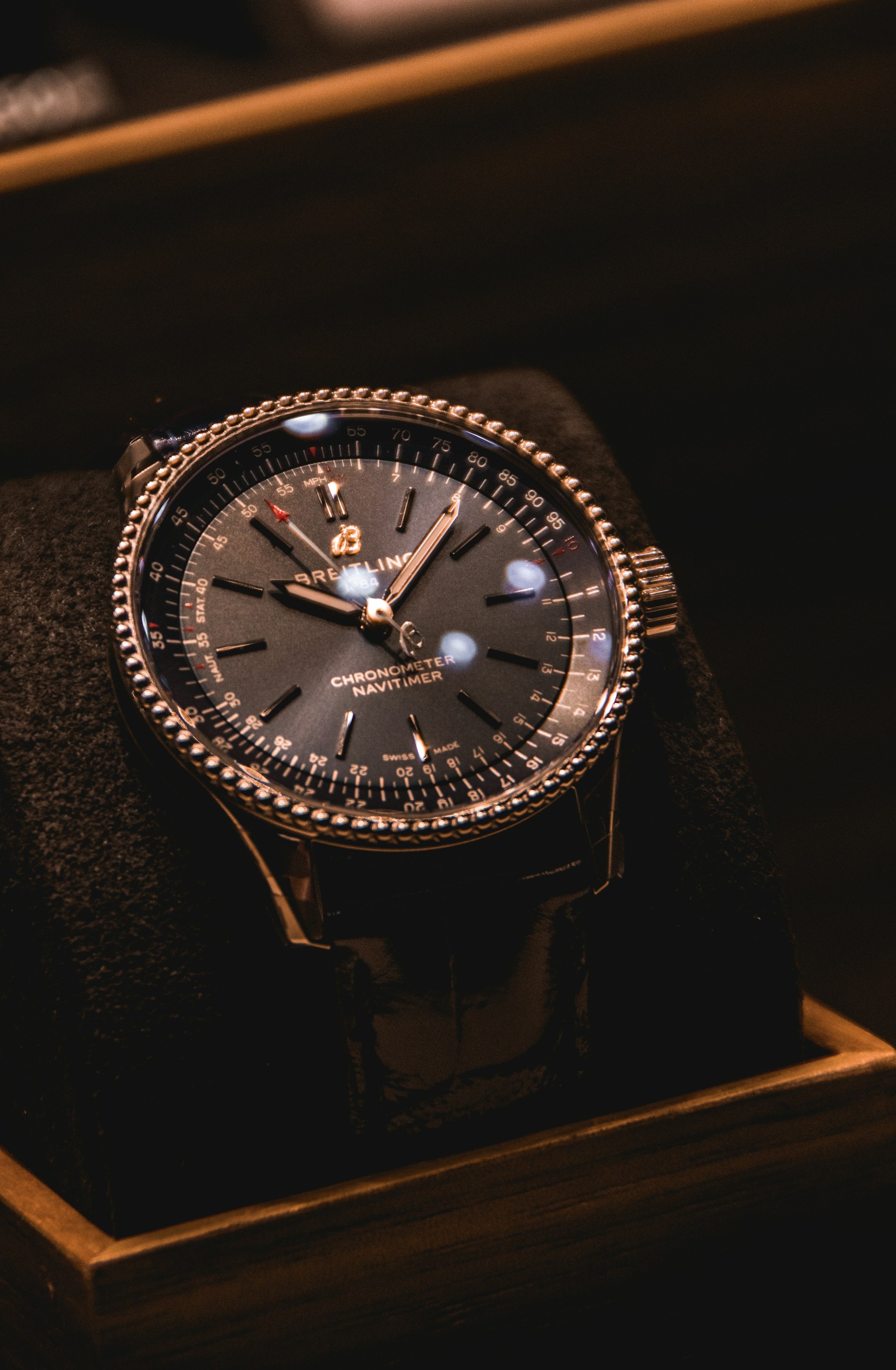 An intricately detailed Breitling watch in a dark presentation box